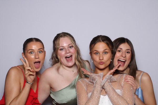 Four young women smiling for Photo Booth photo
