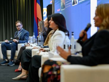 Panel discussion with diverse speakers at a conference.