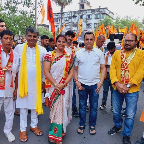 Group of people dressed in traditional attire during a procession.