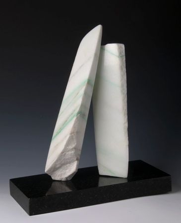 CO Yule Marble sculpture. two upright slivers, one leaning on the other, polished and rough areas