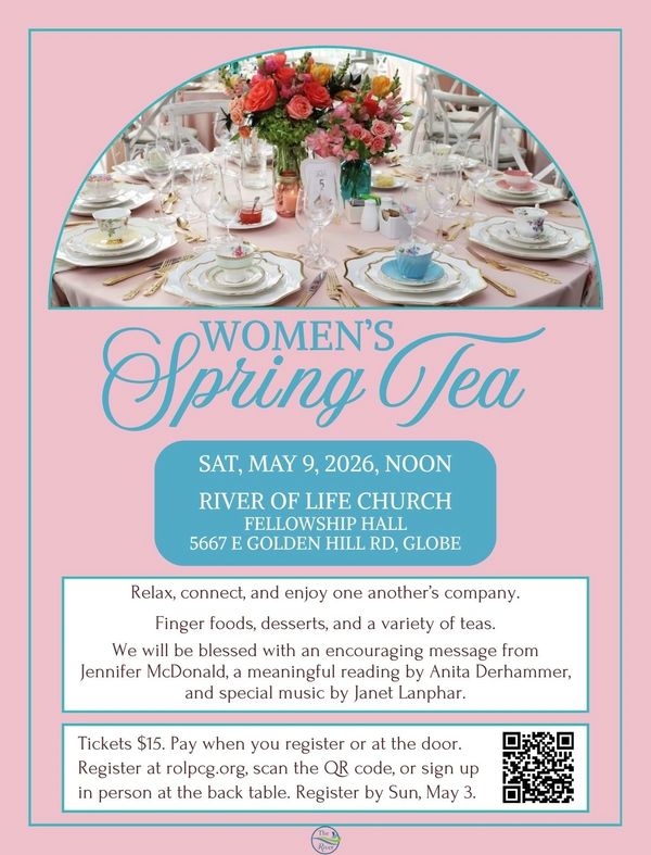 Elegant table setting for Women's Spring Tea event with flowers and fine china.