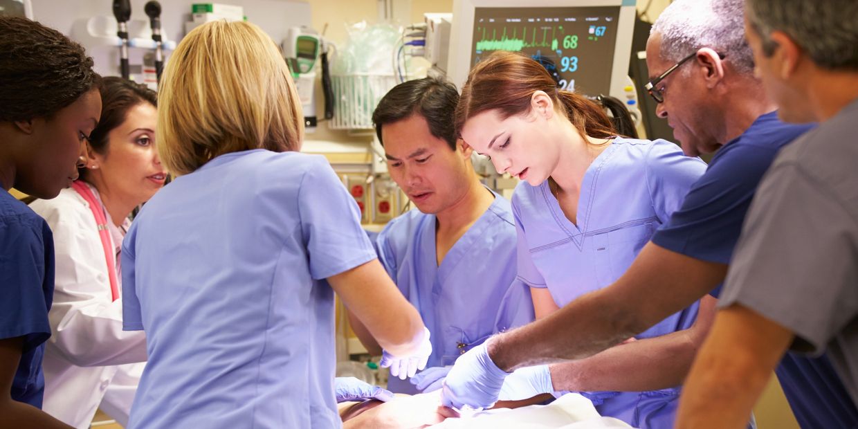 Medical team performing emergency surgery in a hospital operating room.