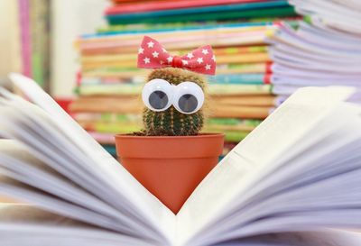 A cactus with googly eyes reading a book.  Training your staff.