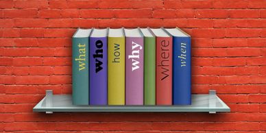 A shelf of books in front of a red wall.