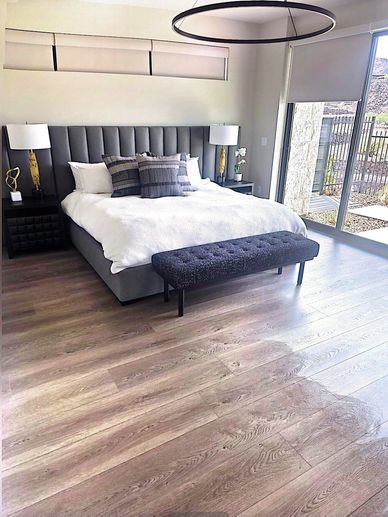 Neatly made bed and vacuumed floors after standard bedroom cleaning in Las Vegas