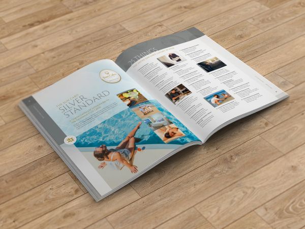 Open magazine with lifestyle and poolside images.