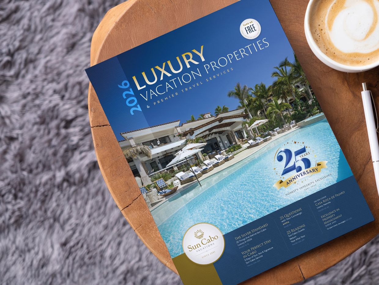 Luxury vacation properties 2026 catalog on a wooden table.