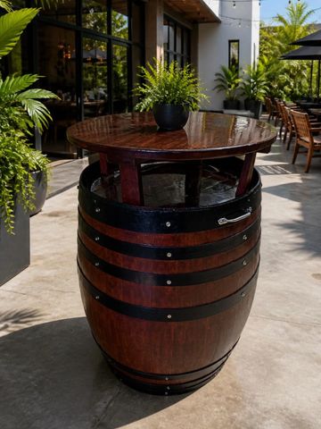 Round wooden barrel table with a plant on top.