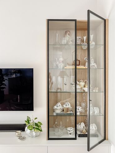 Custom glass display case with framed black doors