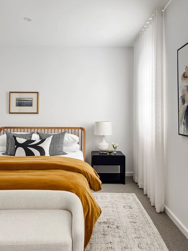 Modern bedroom with transitional rug, velvet doona, linen sheer curtains and Marimekko curtains
