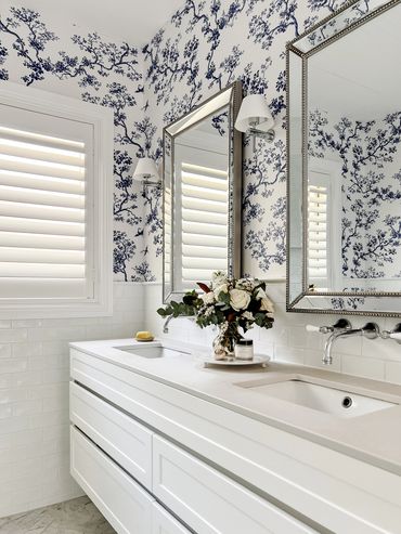 Light-filled Hamptons bathroom with custom Florence Broadhurst wallpaper and shaker cabinetry.