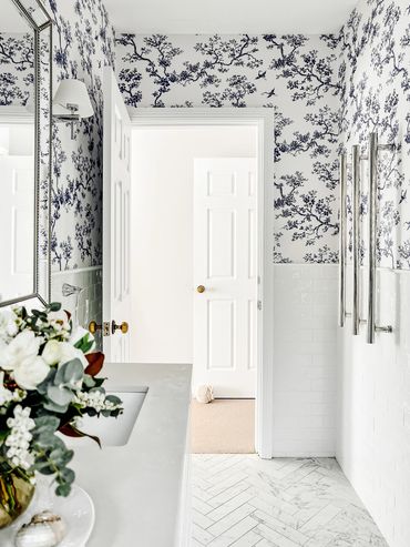 Light-filled Hamptons bathroom with custom Florence Broadhurst wallpaper.
