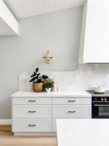 Coastal Kitchen with light grey shaker cabinetry, concrete benchtop and zellige tiles.