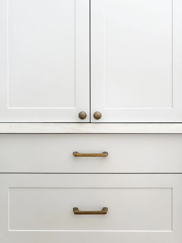Coastal Kitchen with light grey shaker cabinetry and handmade brass handles.
