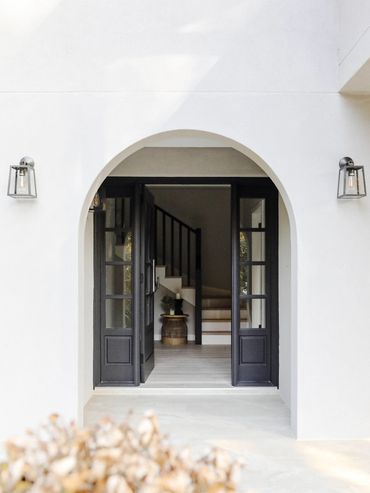 Hamptons Entry with costom black entry door and sidelights. Black Coach lights