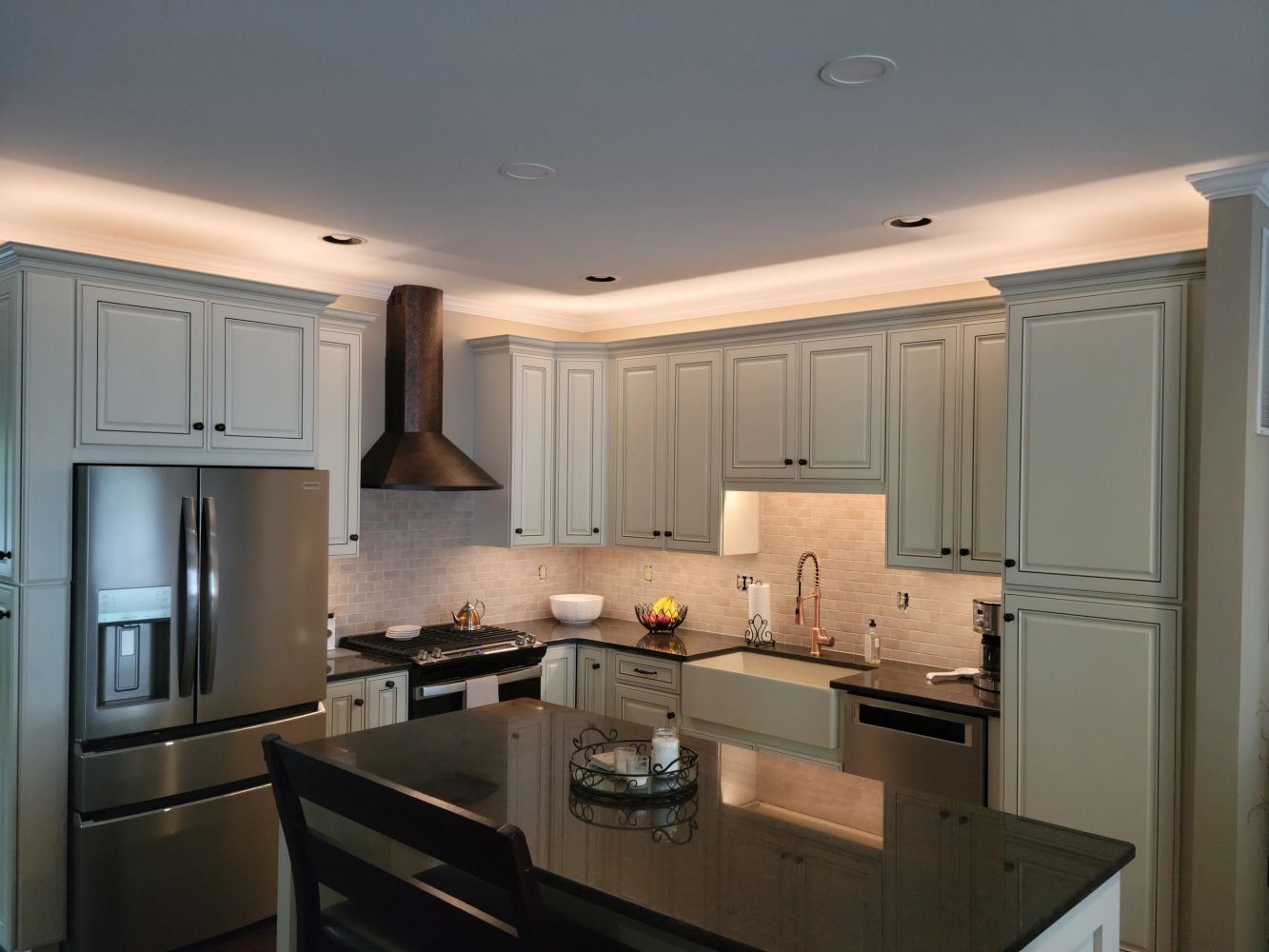 Modern kitchen with stainless steel appliances and white cabinetry.
