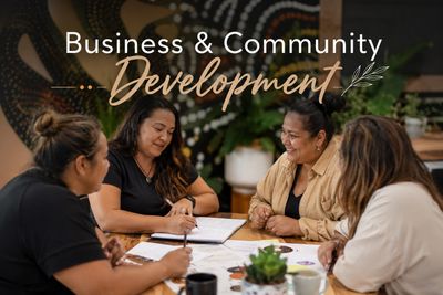 Four women collaborate in a business and community development meeting.