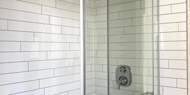 Tile look shower wall surround installed with a tub to shower conversion project.
