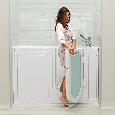 Mobility Bath Systems installed walk in bathtub with accessible outward swinging door for seniors.
