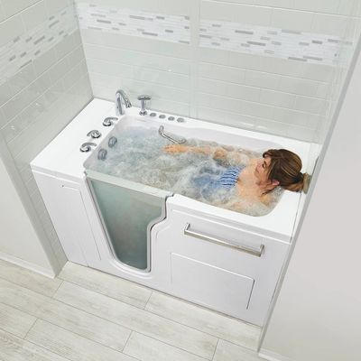 Woman soaking in an Ella's Bubbles walk in bathtub installed by Mobility Bath Systems.