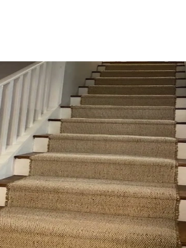 stairs with white rails and beige jute carpet runner