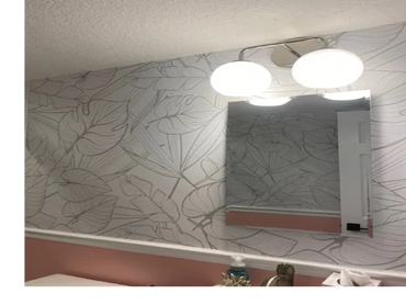 Palm print wallpaper, chair rail and 2-light globe sconce