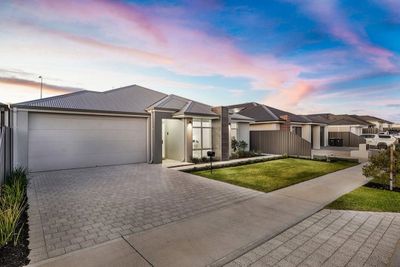 Modern Perth home facade with landscaped front yard at sunset