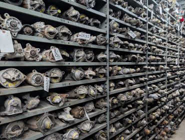 Rows of automotive parts on metal shelves.