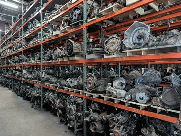 Warehouse filled with car transmissions on shelves.