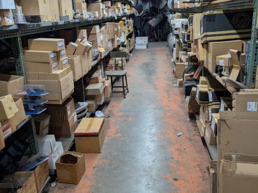 Warehouse aisle with boxes on shelves.