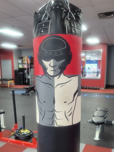 Boxing gym punching bag with a graphic of a boxer wearing a helmet labeled 'BART'.