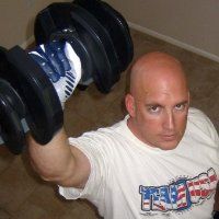Man lifting dumbbell with intense focus.