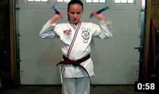 girl performing double nuchaku