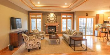 Cozy living room with fireplace and natural light.