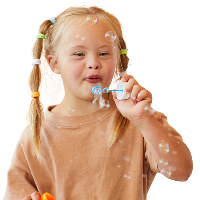 Little girl blowing bubbles.
