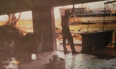 Man looking at boat cargo.