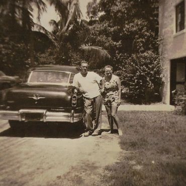 Man and woman next to a car.