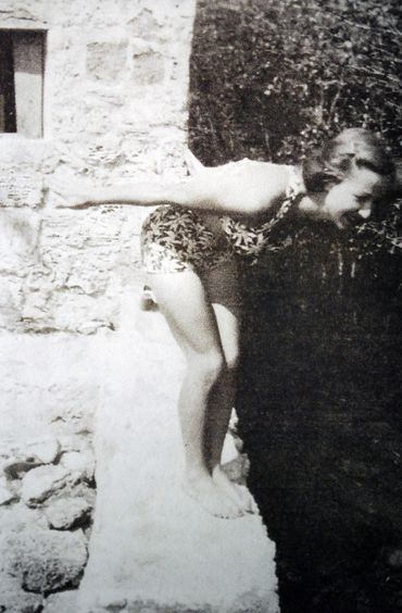 Woman jumping in the water.