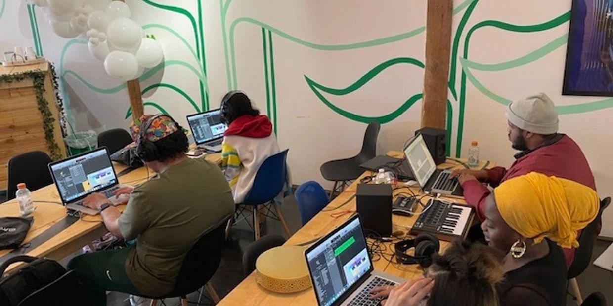People working on laptops in a creative studio.