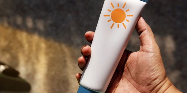person holding sunscreen