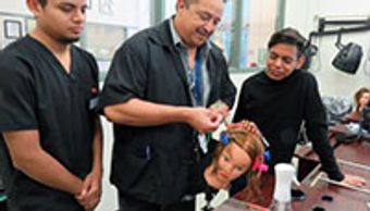 Gilbert Ramirez Department supervisor Cosmetology at Gavilan College showing students how to do it.
