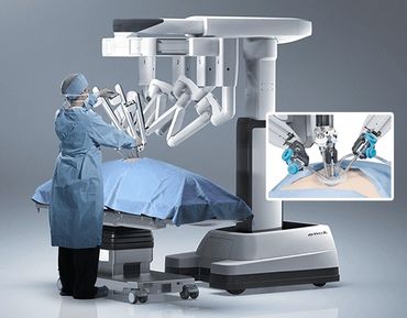 Surgeon operating a robotic surgical system in a sterile environment.