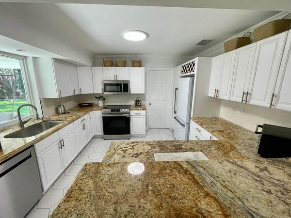 CABINET REFINISHING , NEW BACK SPLASH, AND NEW TILE FLOORING