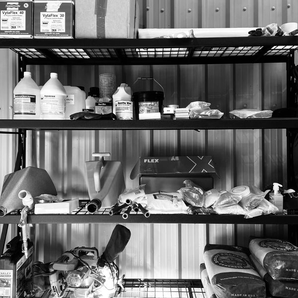 storage rack displaying items used in the manufacture of polished concrete furniture