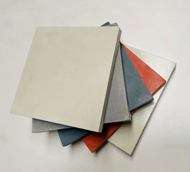 five tiles placed on top of each other in various colours