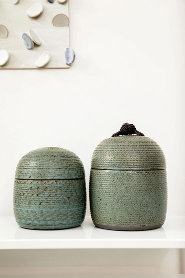 carved stoneware jars with leather knots