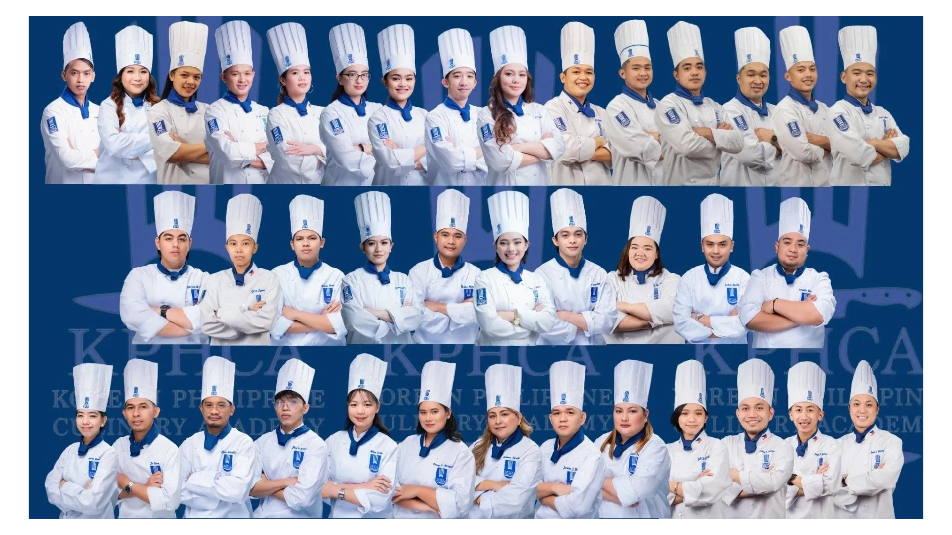 Group photo of chefs in white uniforms and tall hats posing confidently.