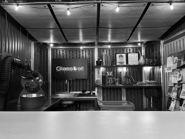 Cozy coffee roastery setup with brewing tools and coffee bags on display.
