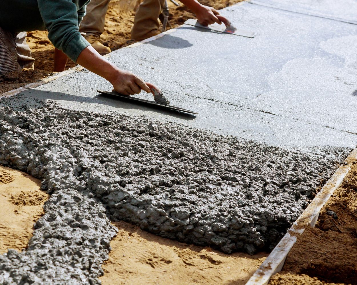 Worker laying fresh concrete for a driveway in Kenosha, Wisconsin