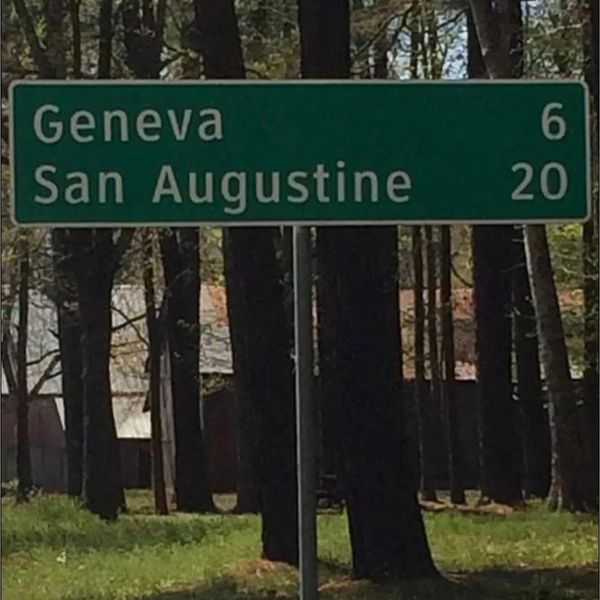 Road sign showing distances to Geneva and San Augustine.